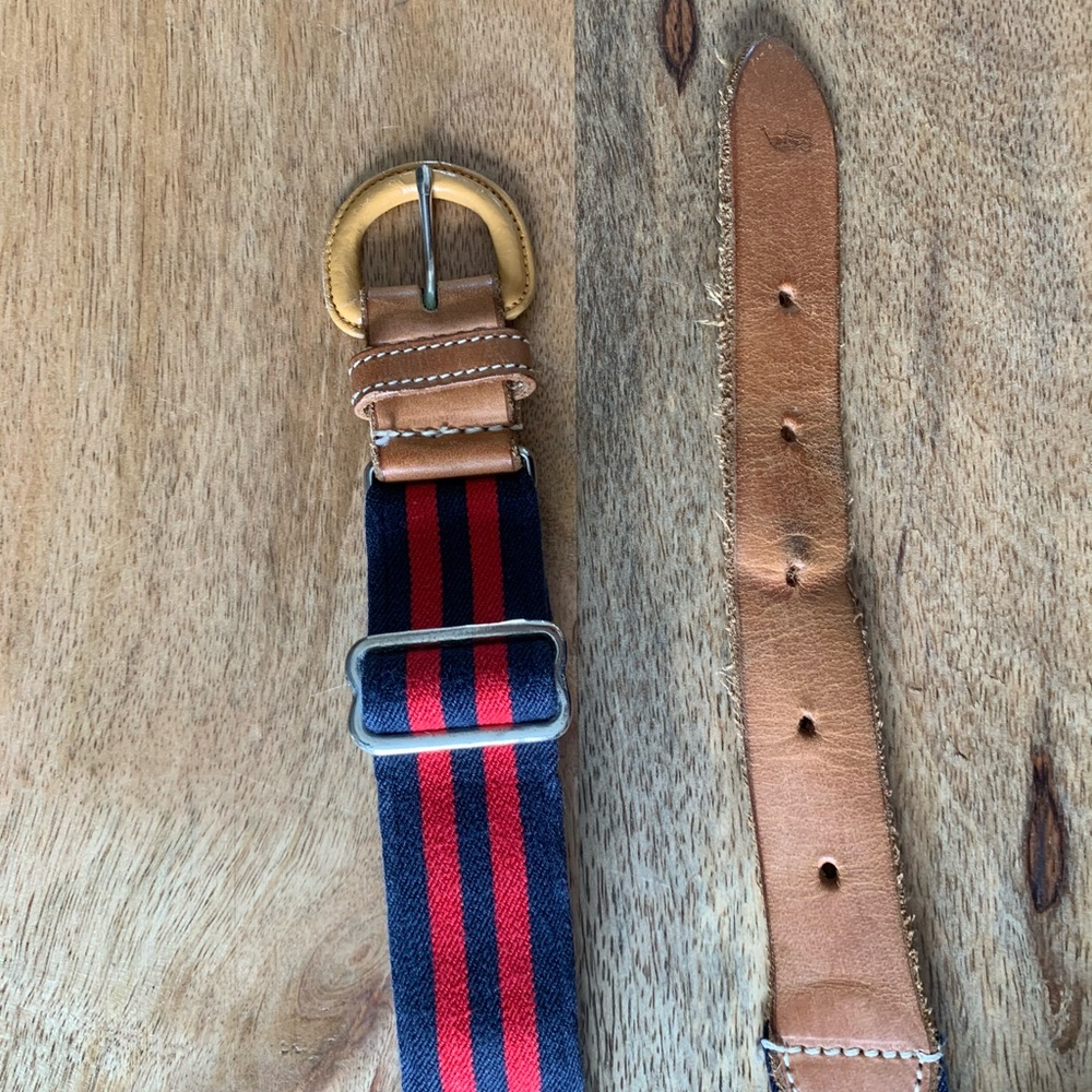 Blue and red striped belt with leather buckle.